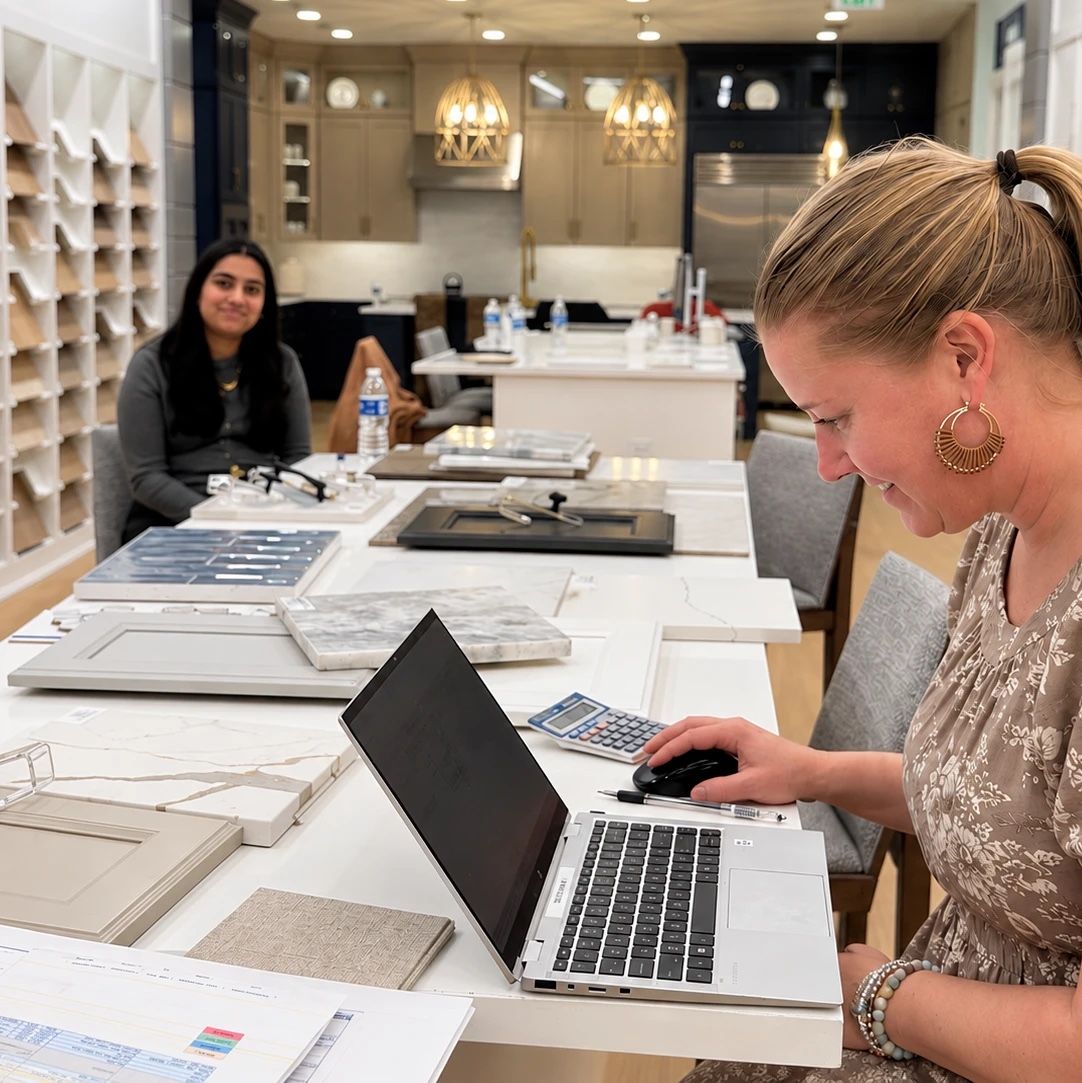 Design team working with a client, reviewing stone and cabinet samples.