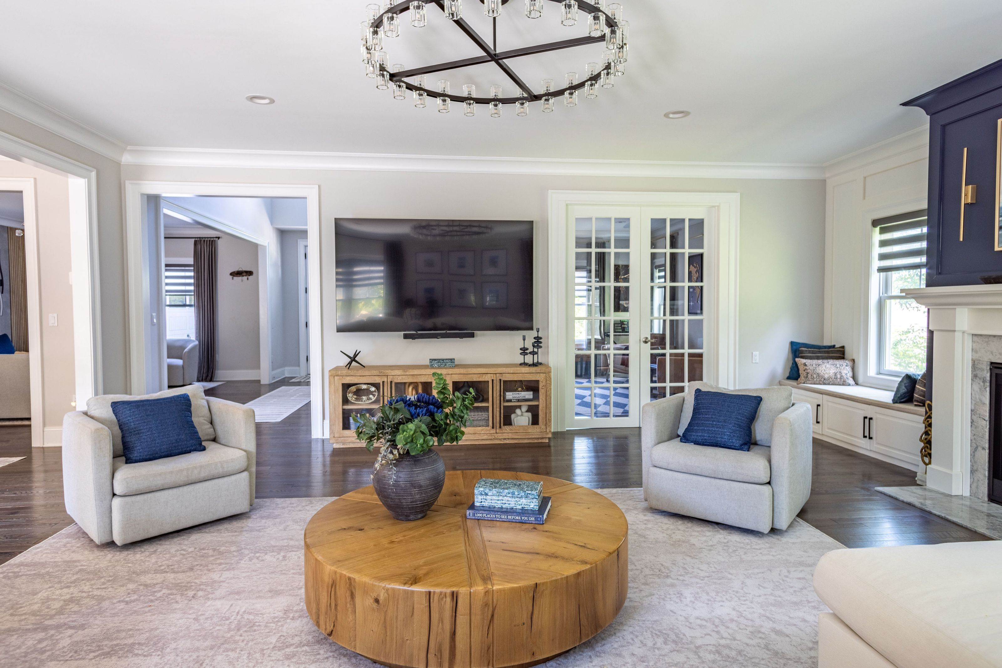 Family room seating area with swivel chairs surrounding a round wood coffee table.