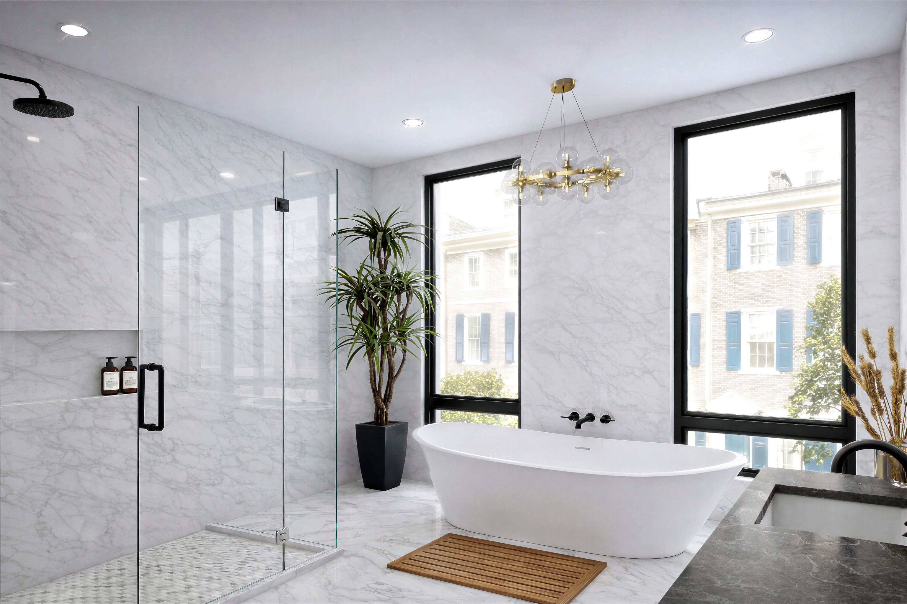 Primary contemporary bathroom with a freestanding soaking tub, glass-enclosed shower, and glass chandelier.