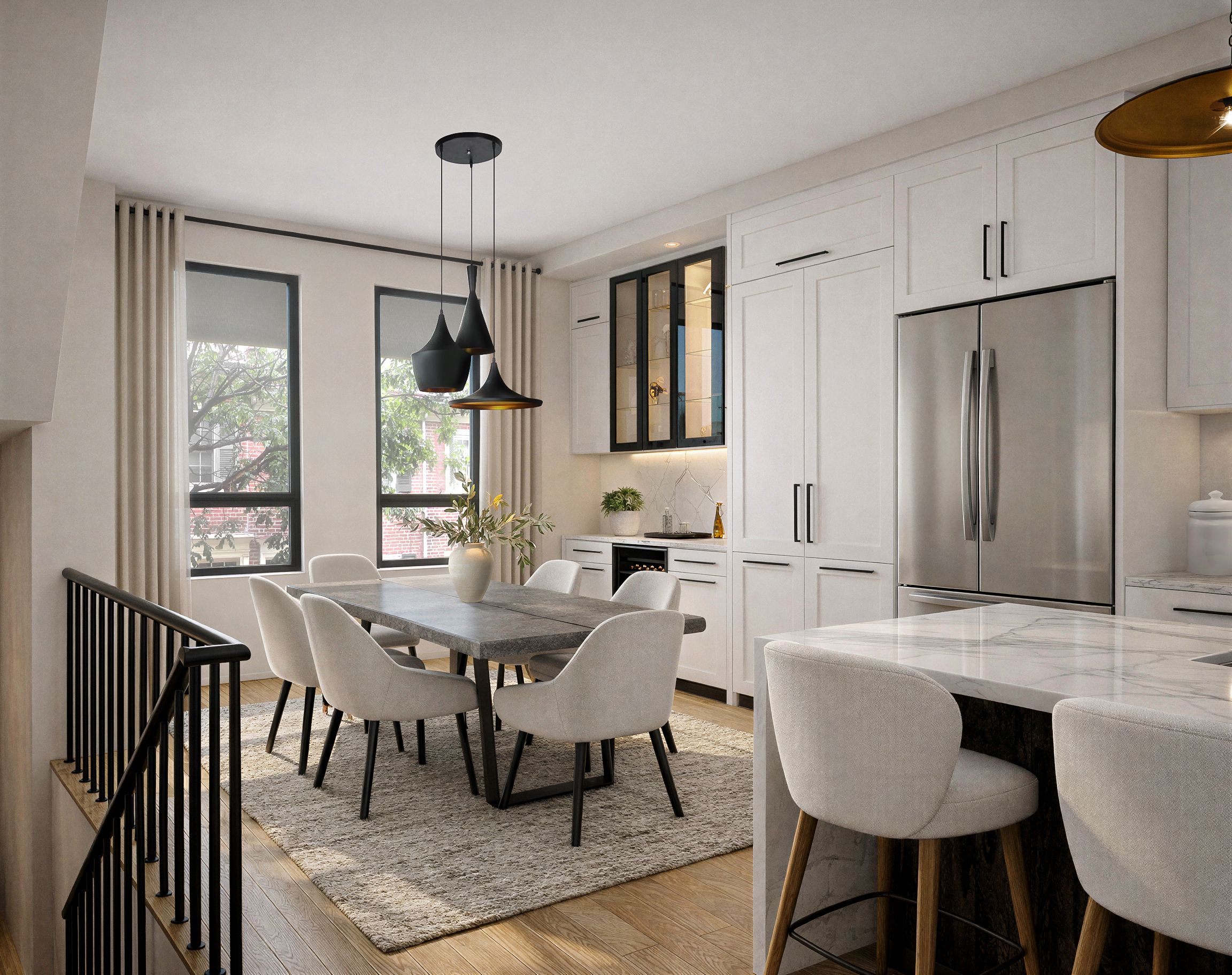 Contemporary dining area with a wood table and black sculptural pendant light beside an open kitchen.
