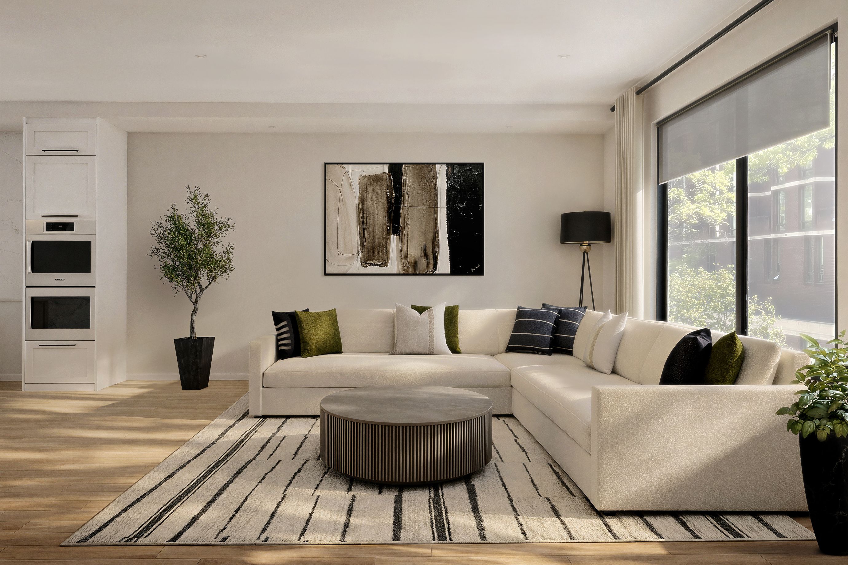 Contemporary living room with clean lines, featuring a cream sectional sofa, round concrete fluted coffee table, framed abstract artwork, and olive green, black and tan accents.