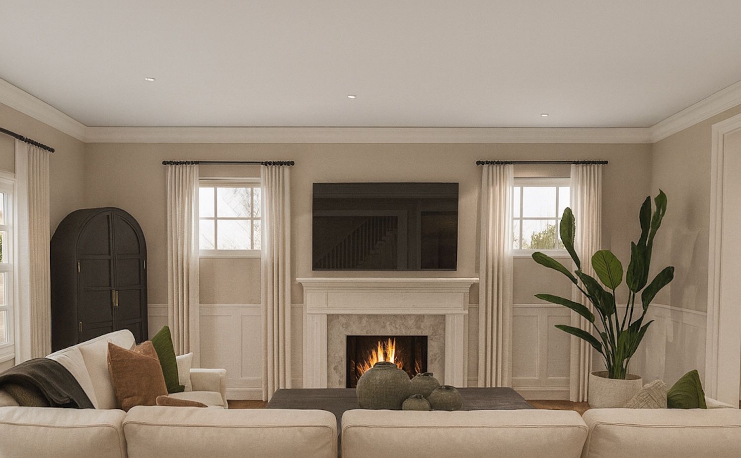 Living room with a marble fireplace surround, an arched doorway, and a sofa positioned in front of the fireplace.