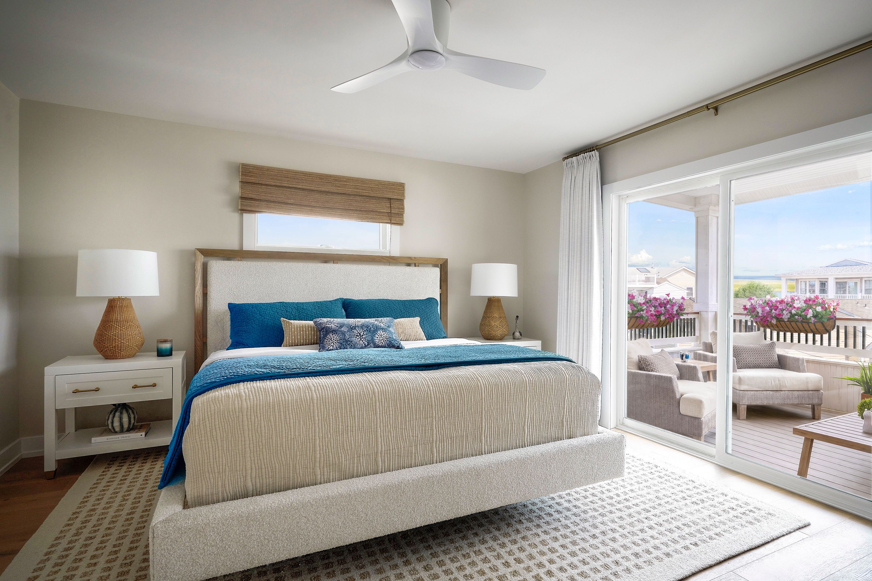 Bedroom with sliding glass doors opening to a furnished balcony.