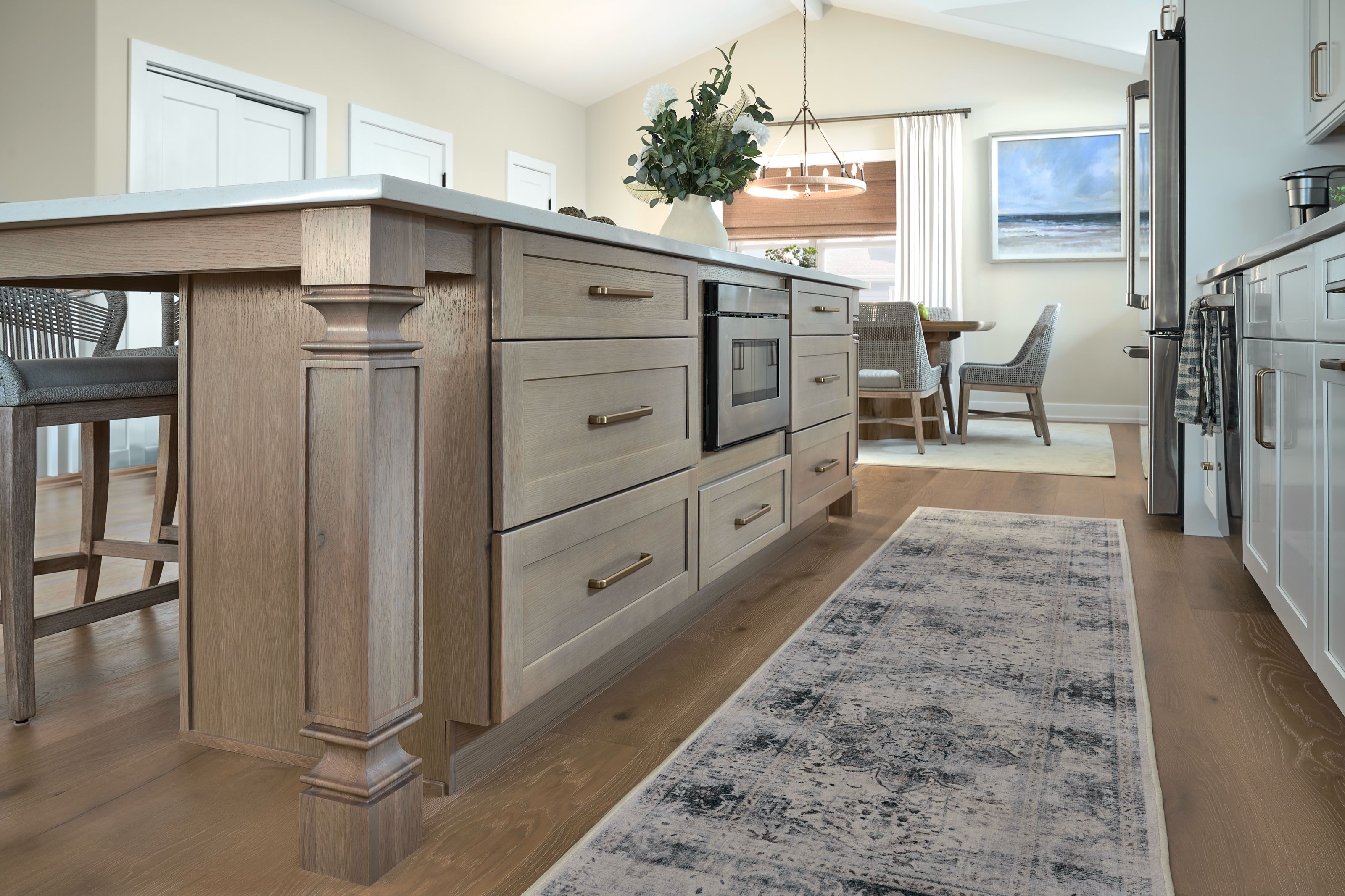 Kitchen island detail featuring a turned wood post and patterned runner.