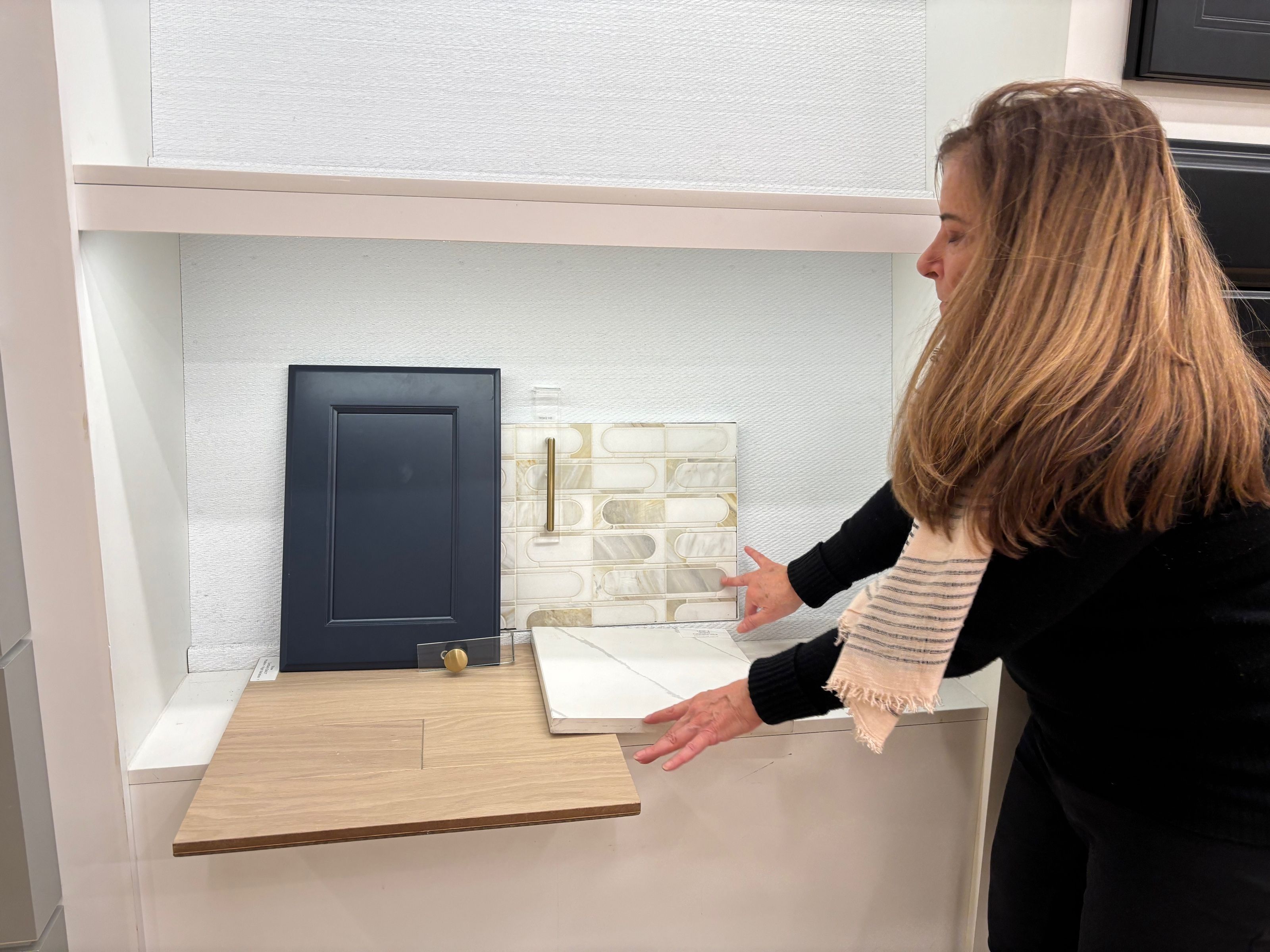 Designer reviewing cabinet, tile and countertop samples.